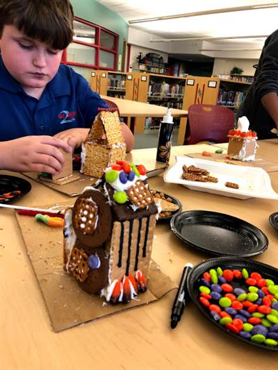 boy builds ginger bread house