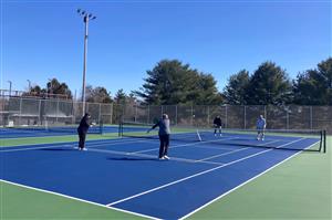 four people play pickleball at simsbury farms