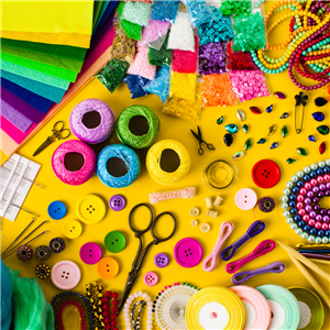 Colorful craft supplies on a yellow background
