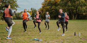 Group of adults doing exercises in a field