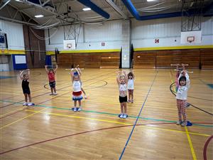 Baton class holding their batons in the air