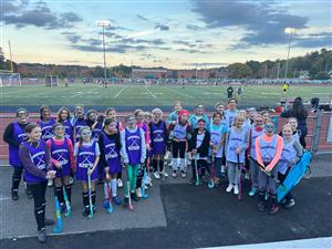 Group photo of the field hockey team on the turf
