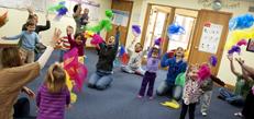 Group of young kids playing with scarves