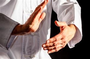 Hands performing tai chi move